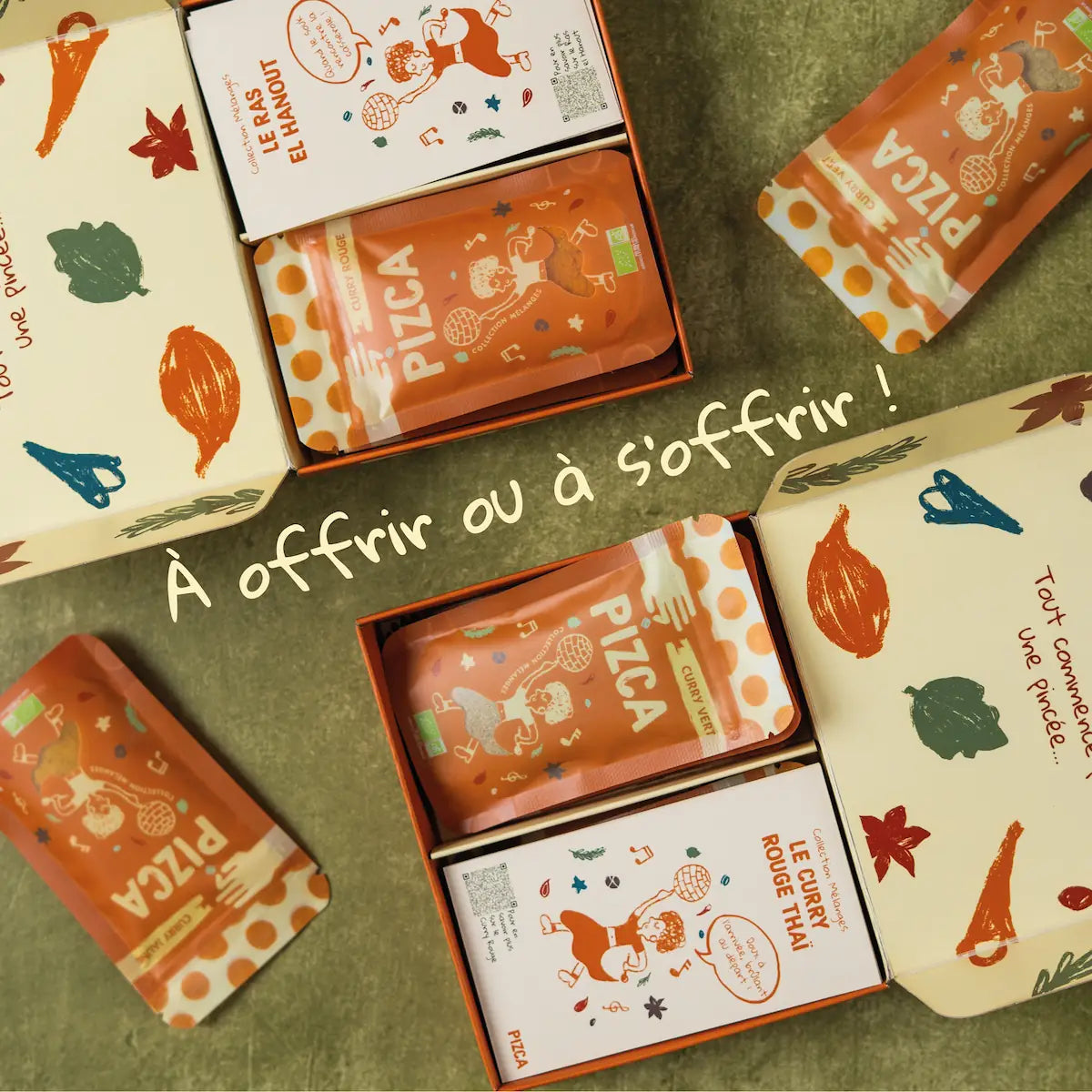 Vue de dessus du coffret Pizca ouvert présentant des sachets de Curry Vert et Curry Rouge bio avec leurs livrets de recettes illustrés